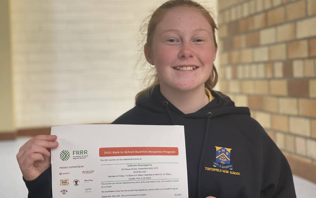 Tenterfield High School's Amelia Robertson with her e-voucher. Tenterfield Lions Club is urging families to redeem their vouchers before they go astray.