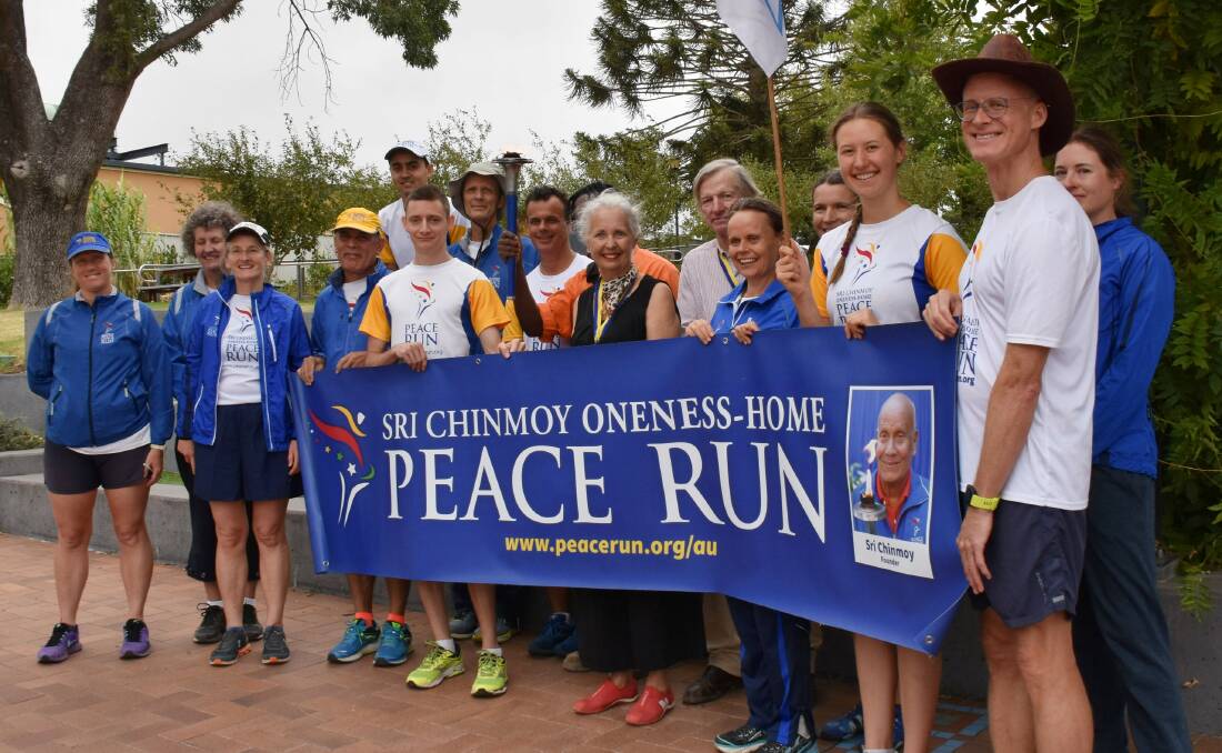 Julia and Philip Harpham are now on the world Peace Run map after runners stopped by Bruxner Park to present the pair with Torch Bearer awards for their work with refugee families.