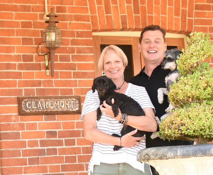 Andrea and Darren Rutley, pictured here with 'Snoop Dog' and 'Charlie Bear' on the front verandah of Claremont. The couple working remotely from Tenterfield during their stayovers.