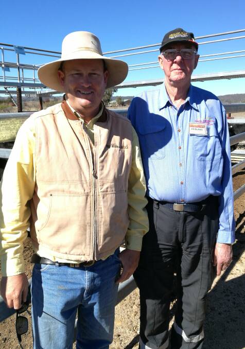 Ray White Rural's Ben Sharpe, pictured here with BlazeAid camp coordinator Ed Bland, will be eating well after securing the donated BlazeAid heifer.