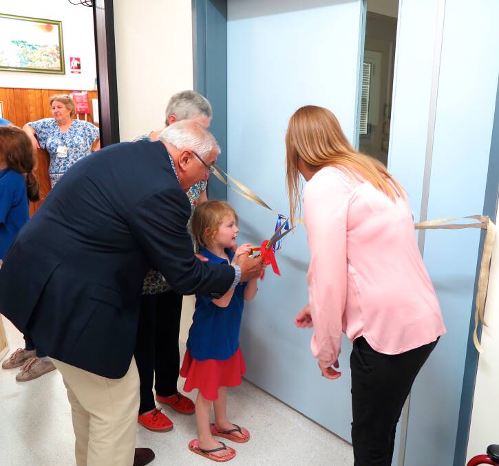 MP Thomas George and Urbenville MPS Nurse Manager Nicole Ellevsen help Urbenville Public School student Amelia Russ cut the ribbon along with MPS Network EO/DON Nancy Martin (obscured).