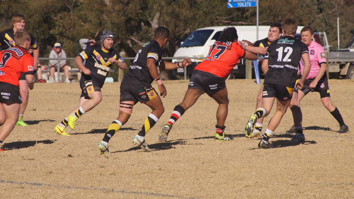 Floyd Oxford tackles Inglewood's Shane Hooper as Jake Adam, Geoff Swan and Jacob Harding go in to help out. Photo courtesy of Stanthorpe Border Post.