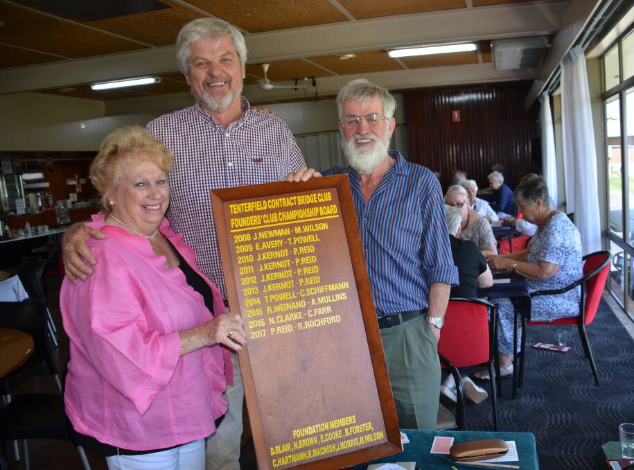 Club president Patricia Barry congratulates 2017 Tenterfield Contract Bridge champions Peter Reid and Dick Rochford on topping the points board this year.