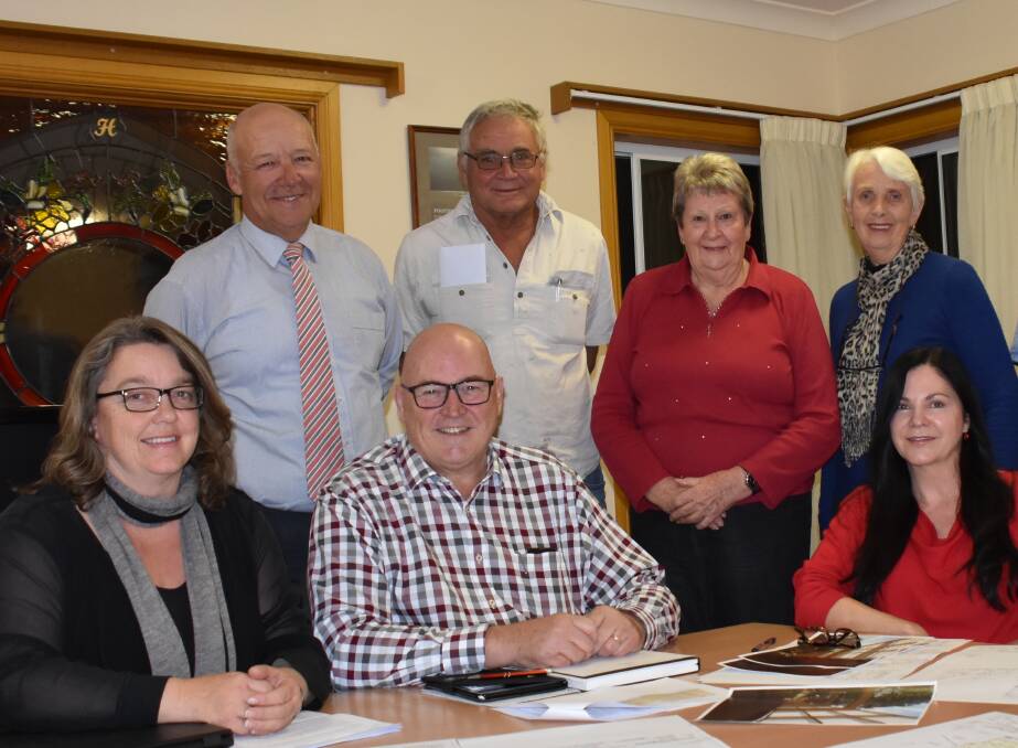 Tenterfield Care Centre's (seated, from left) secretary Beth Moore, chair Greg Sauer and general manager Fiona Murphy with (standing) treasurer Allan Donges, outgoing board member Bob South, and re-elected board members Carol Schiffman and deputy chair Rhonda Rovera. Not in the photo are Max Whitford and Sylvia Grigg, newly-elected to the board. (File photo.)