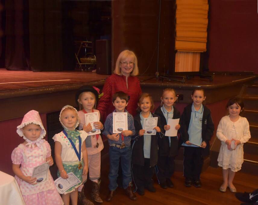 Adjudicator Rob Christmas with competitors in the six years and under nursery rhyme section.