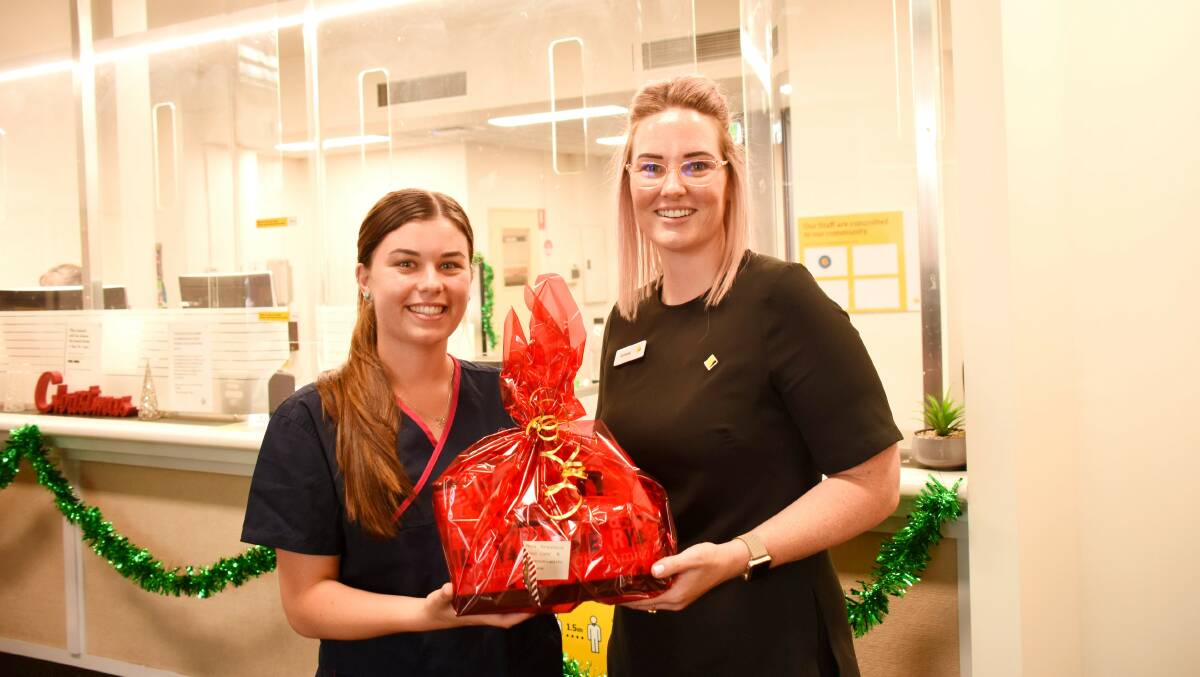 Total Care's Sophie Kirby and Commonwealth Bank branch manager Gemma Taylor with one of the hampers to be delivered on Christmas Eve.