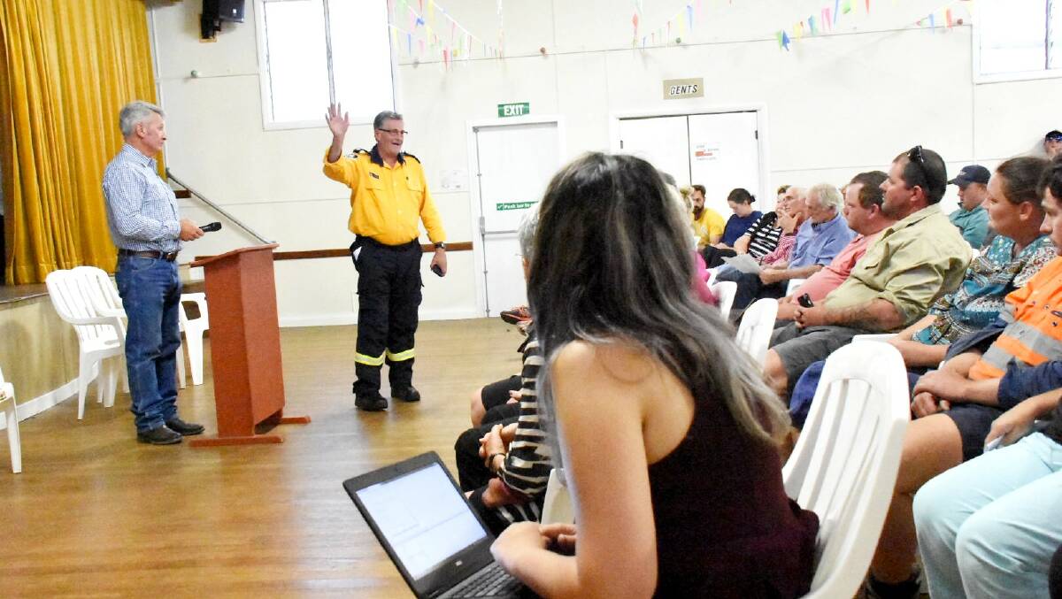 Tenterfield mayor Peter Petty and RFS public liaison officer Paul McGrath address the community meeting at Wallangarra Hall on Friday night.
