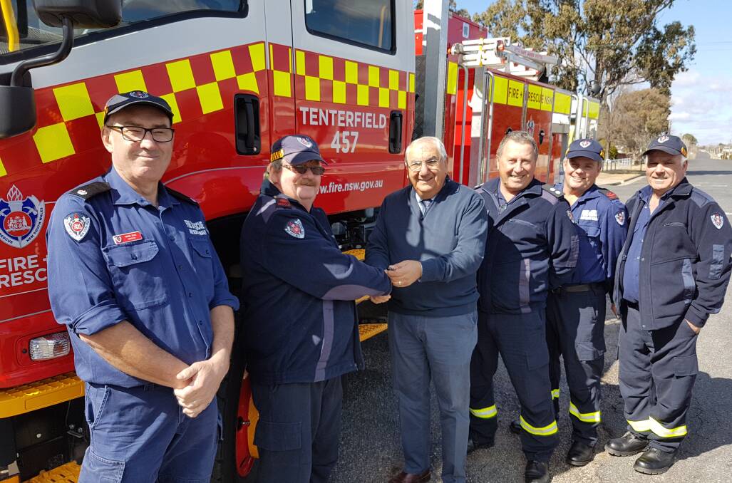 MP Thomas George (centre) officially hands over the keys to the new tanker to Tenterfield firefighters (from left) Wayne Zikan, Chris Coker, Tom Cooper, Greg Blackler and John McCormack.
