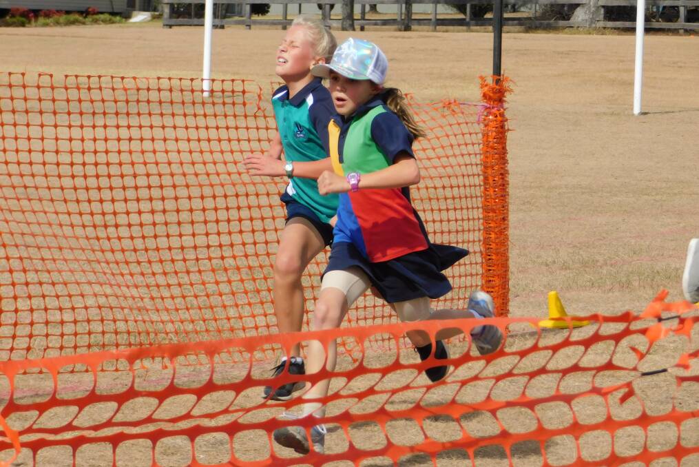 Beth gets a nose ahead of her Glen Innes Public School rival in the 10 years girls cross country district competition hosted by TSHPMPS.