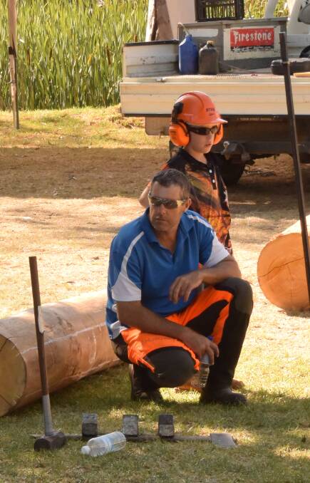 Chainsaw racing steward Jason Chisholm and offsider son Christopher keep an experienced eye on proceedings during the event.
