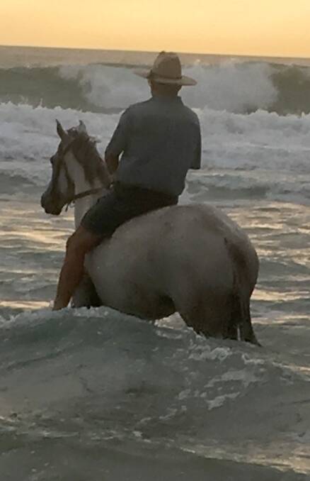 Phillip Willcocks rides bareback into the surf, a rare opportunity for a country rider.