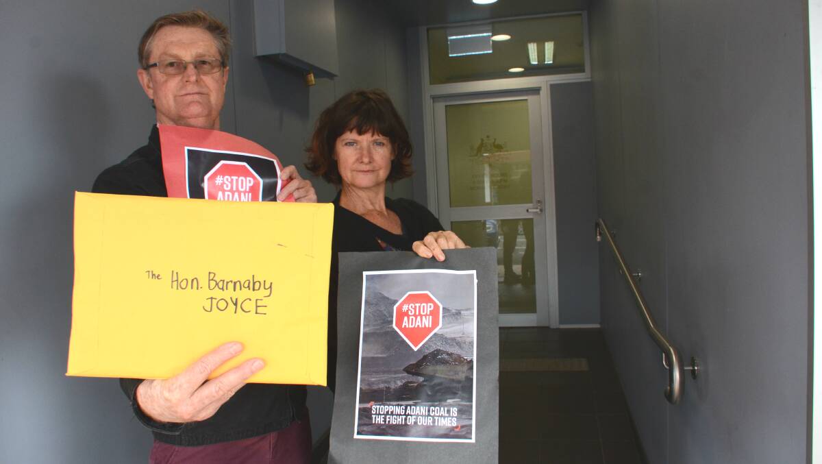 Tenterfield Climate Action Network's David Townes and Gail Galloway deliver the 75 protest letters to Barnaby Joyce's office on Monday.