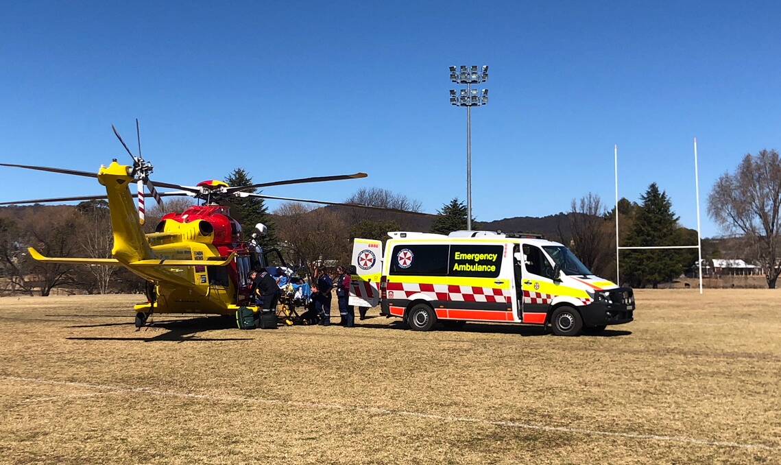 The Wallangarra quad bike accident victim is transferred into the waiting helicopter at Federation Park on Tuesday afternoon.