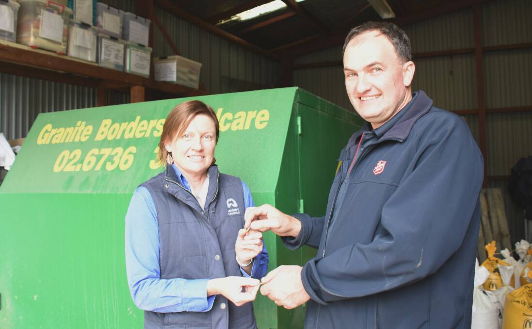 Deal: Granite Borders Landcare's Mandy Craig hands over the keys of the donated trailer to the Salvo's Joel Soper, in exchange for a dollar.