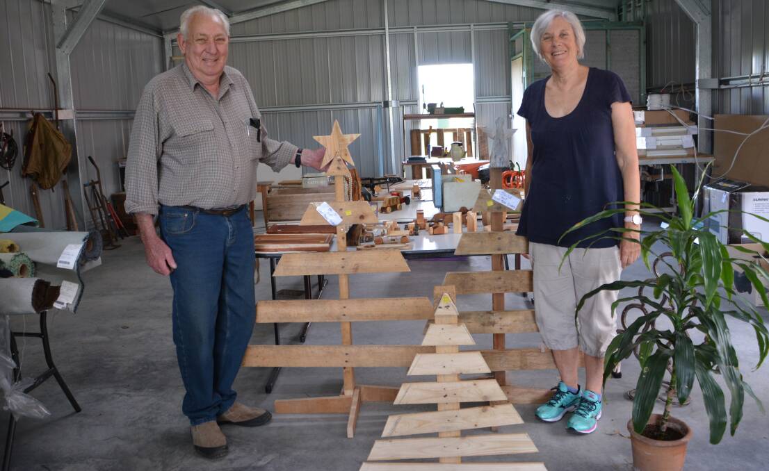 Rex Holley and Ruth O'Connell with a selection of Men's Shed Christmas trees.