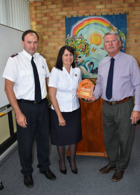 Nine years of extraordinary service: Salvos Joel and Yolande Soper are presented with a commemorative plaque by Mayor Peter Petty. Photo: Donna Ward.