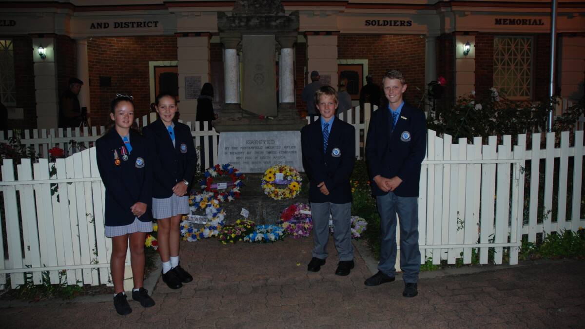 St Joseph's School students Matilda Mitchell, Heidi Aquilini, Lindsay Butler and Jackson O'Neill laid a wreath at the Tenterfield Soldier's Memorial this morning during the Anzac Day dawn service.