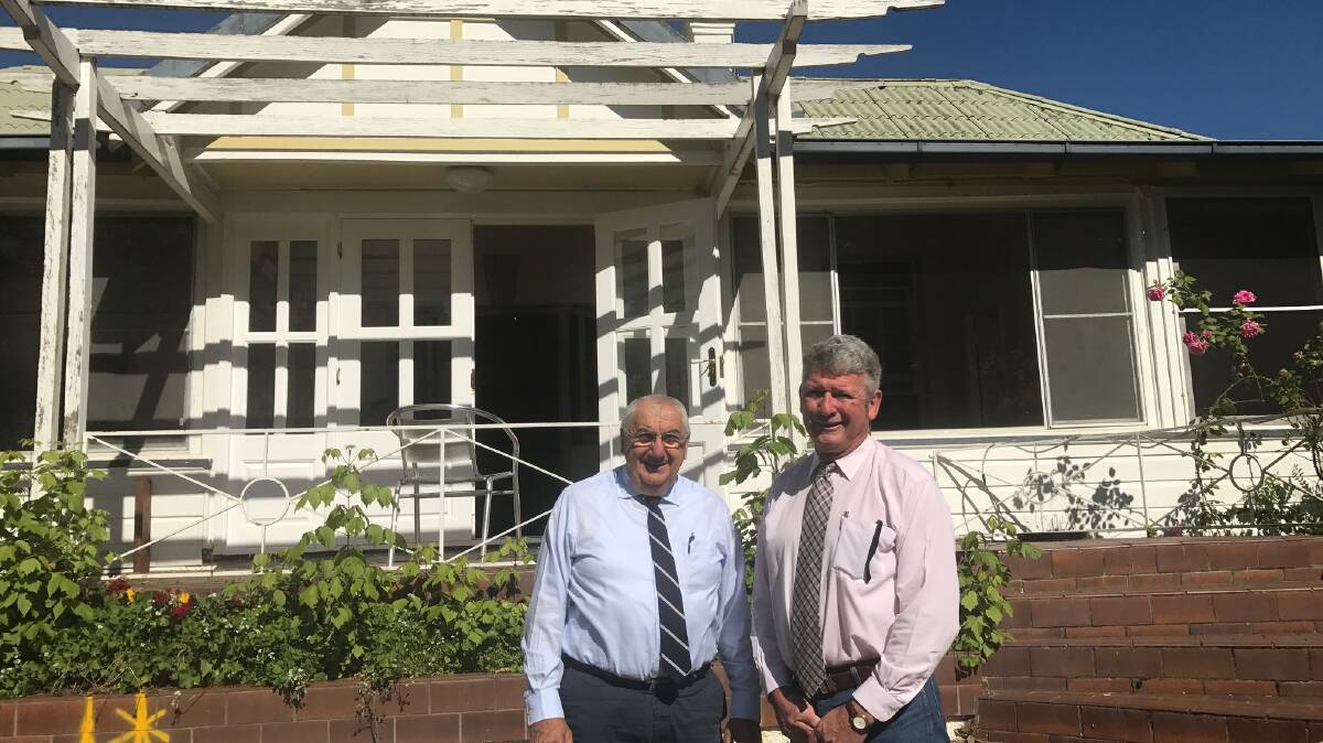 Keba House, pictured here behind MP Thomas George and Tenterfield mayor Peter Petty, was once the home of Roger and Pat Braham and their family.