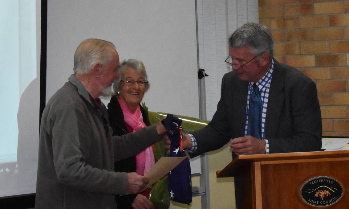David and Cushla Hones accept their citizenship certificates and Australian flag from mayor Peter Petty.