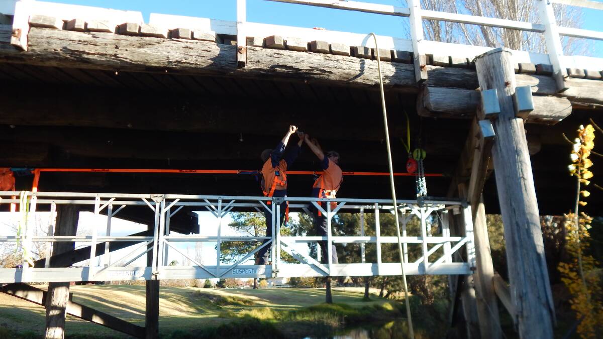 Council workers check on how the Molesworth Street bridge is settling in after its 2012 restoration.