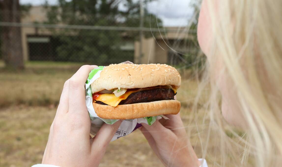 Meat and greet: A consumer eyes off a Rebel Whopper from Hungry Jack's, which is made with a plant-derived patty that will soon be coming off a production line in Wodonga. Photo: James Wiltshire 