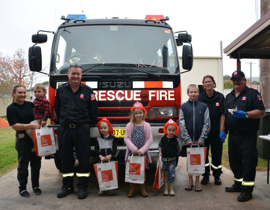 OPEN DAY: Fire fighters Paul Seary and Chris Coker with Charmaine, Jesse, Lincoln, Elanor, Theo, Henry and Danielle at the Tenterfield station on Saturday. Photo: Melinda Campbell