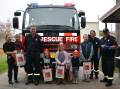 OPEN DAY: Fire fighters Paul Seary and Chris Coker with Charmaine, Jesse, Lincoln, Elanor, Theo, Henry and Danielle at the Tenterfield station on Saturday. Photo: Melinda Campbell