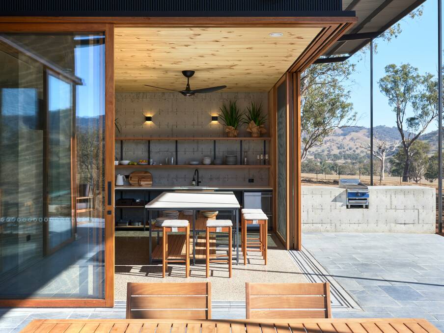 SMOOTH: Sliding doors from the kitchen allow for free flow onto the bluestone patio. Photo: Barton Taylor