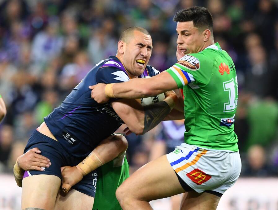 The Storm's Nelson Asofa-Solomona is tackled by the Raiders defence during last season's NRL Qualifying Final match at AAMI Park. The two premiership contenders clash again on Saturday night. Photo: Quinn Rooney/Getty Images