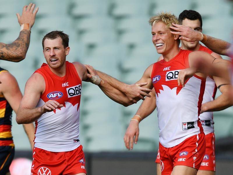 Swans coach John Longmire has come to the defence Isaac Heeney (R) after isolation controversy.