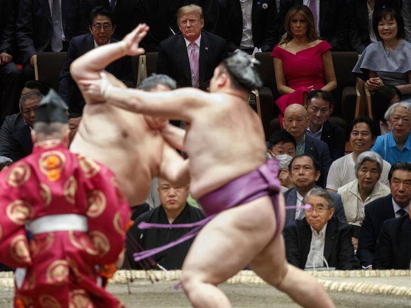 President Donald Trump attends a sumo tournament with Japanese Prime Minister Shinzo Abe in Tokyo.