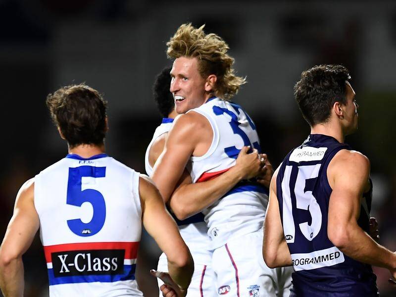 Western Bulldogs Aaron Naughton (centre) may miss their AFL elimination final through injury.