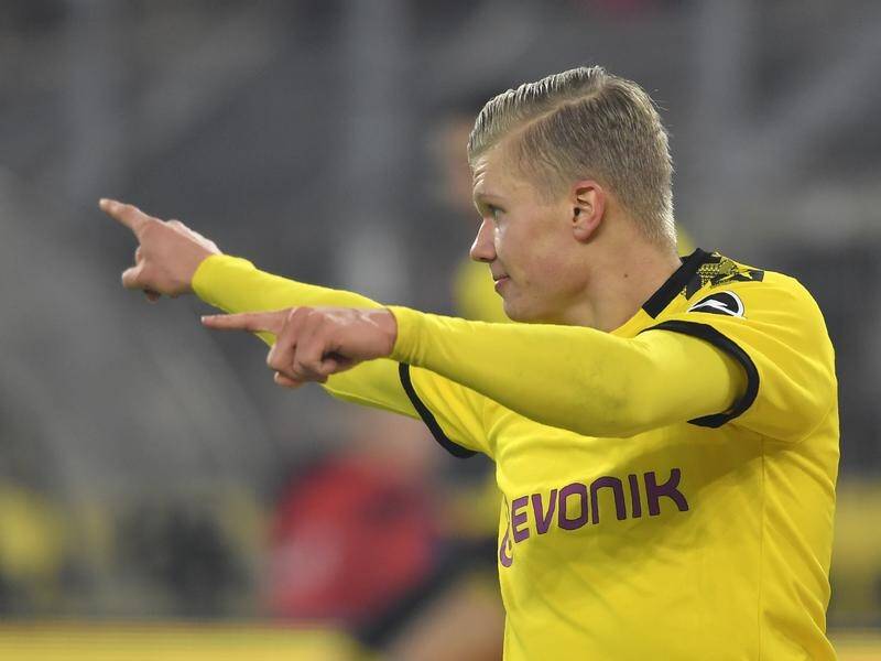 Erling Haaland celebrates scoring Dortmund's third goal against Eintracht Frankfurt.