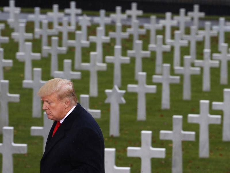 Donald Trump, seen at an American cemetery in France, spent much of his time in Paris alone.