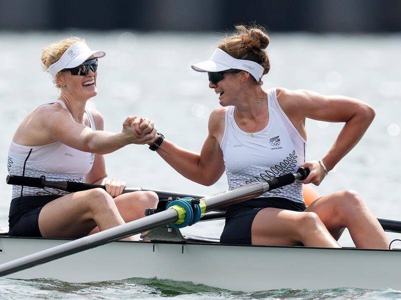 Rowers Grace Prendergast (l) and Kerri Gowler celebrate winning New Zealand's first gold in Tokyo.