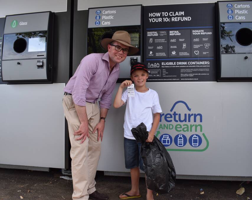 The state's champion recycler. Charlie Crouch depositing another 52 bottles and cans. He's with Adam Marshall MP.