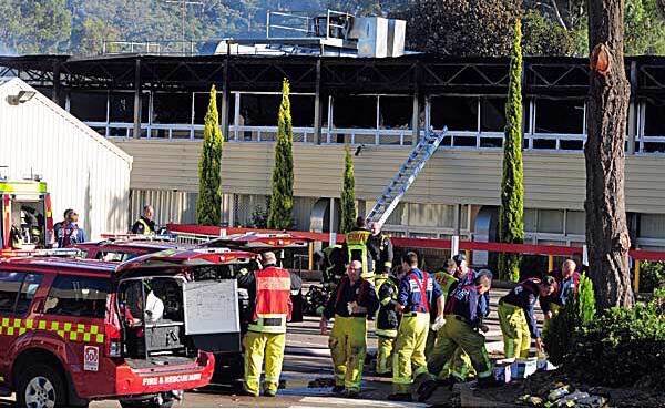 DELIBERATELY LIT: Firefighters at the scene of the blaze on March 18, 2012, at Oxley High School which left a damage bill of $12 million. Photo: Robert Chappel