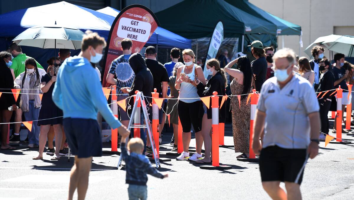 People queue to receive a COVID vaccine at a Bunnings hardware store in Brisbane in October. Picture: Getty Images